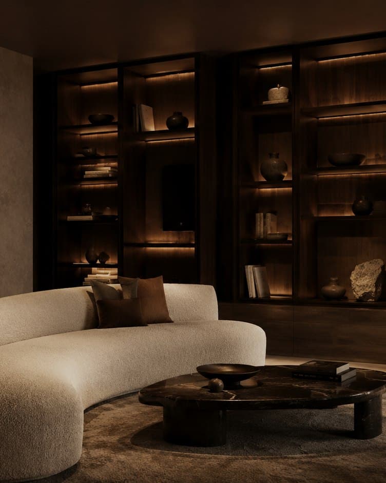 A lounge finished in dark walnut with low seating