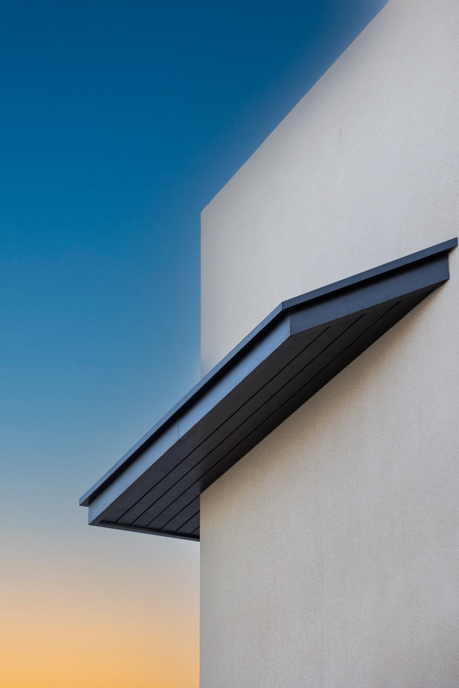 Dark canopy over the upper window of The Cube 61 against a dusk sky, a LKYOOB commission