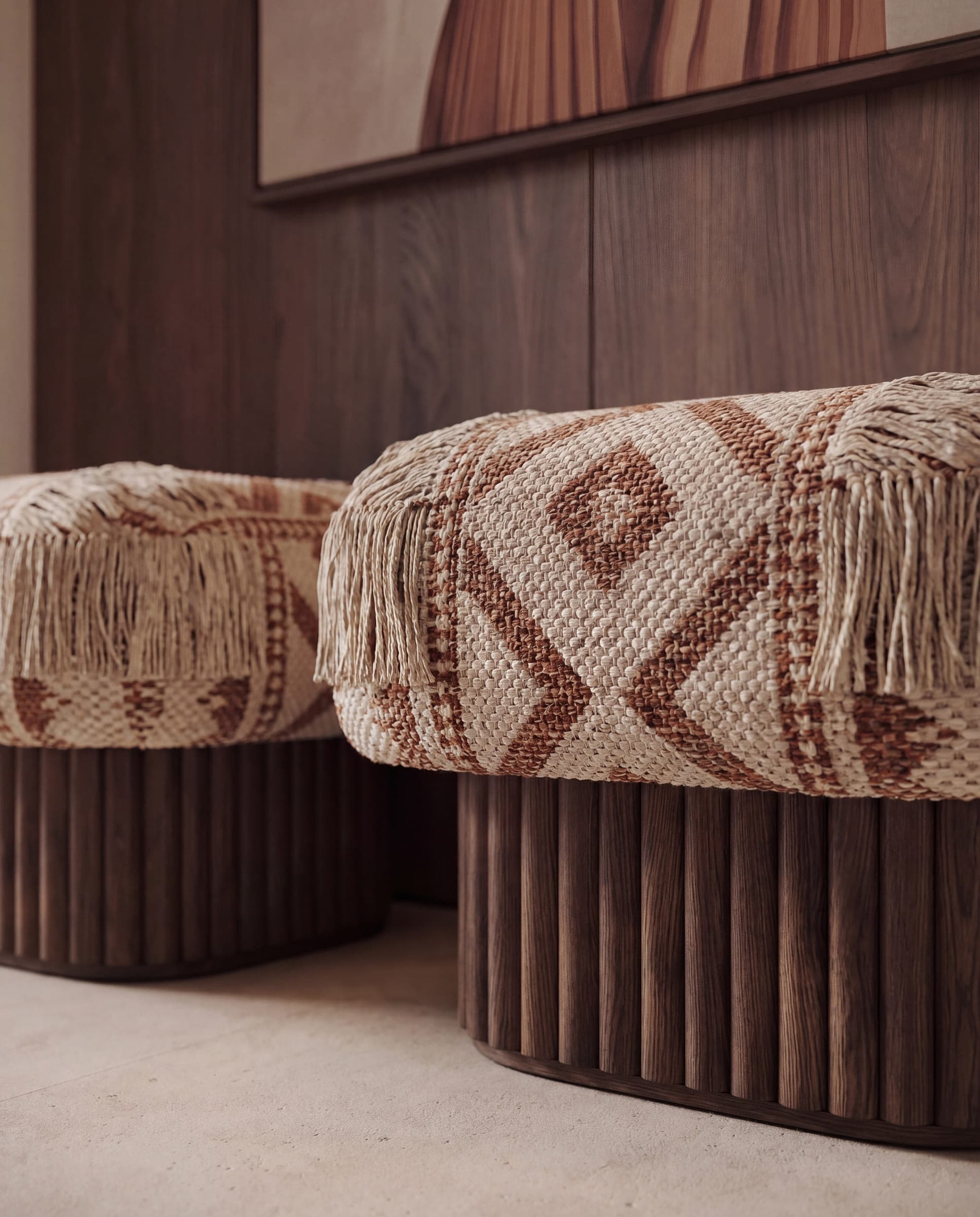A woven cream and brown throw folded over the fluted timber base of a bed, in warm side light — material study by LKYOOB