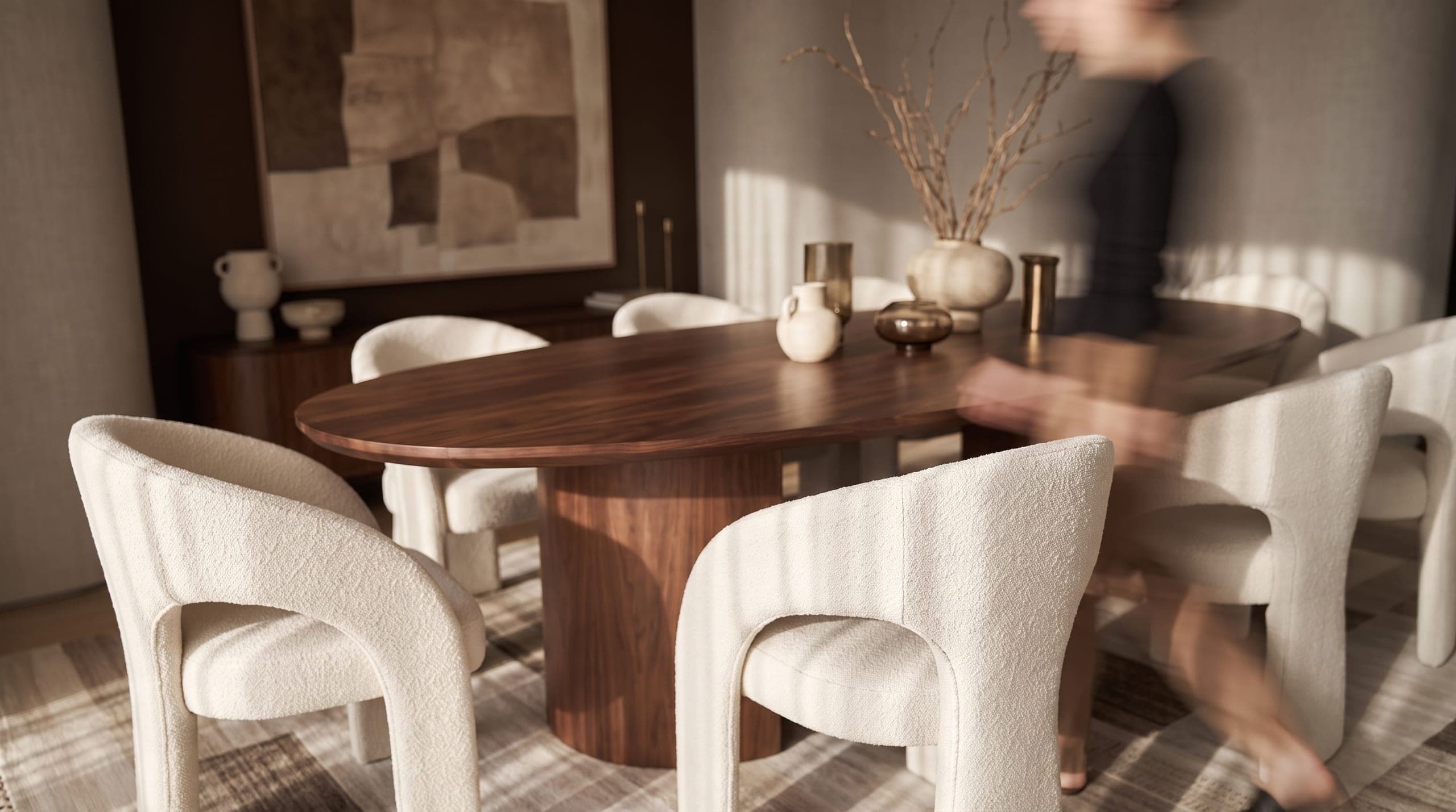 A close view of a boucle dining chair below hung artwork