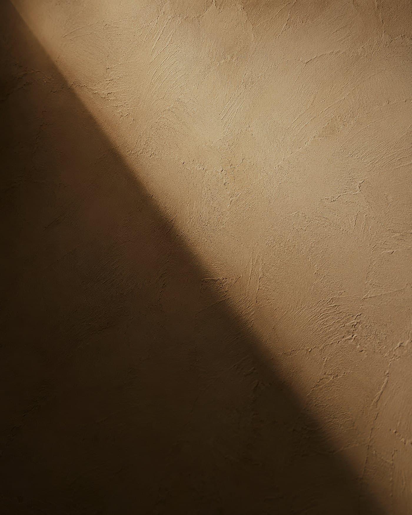 Hand-trowelled lime plaster wall with a soft diagonal beam of warm evening light — material study by LKYOOB