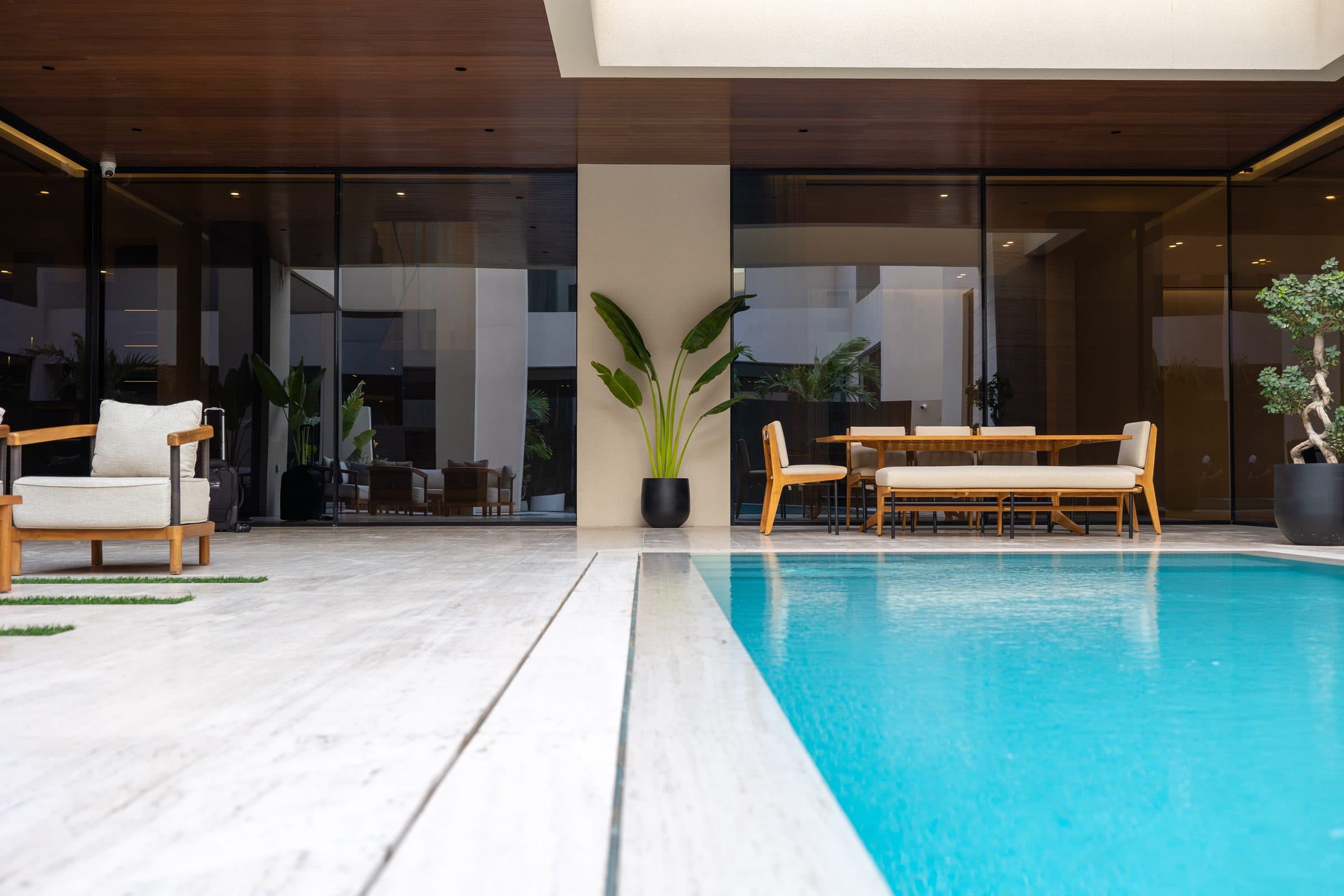 Covered outdoor terrace beside the pool with dining in the shade, at The Travertine Villas, a LKYOOB commission