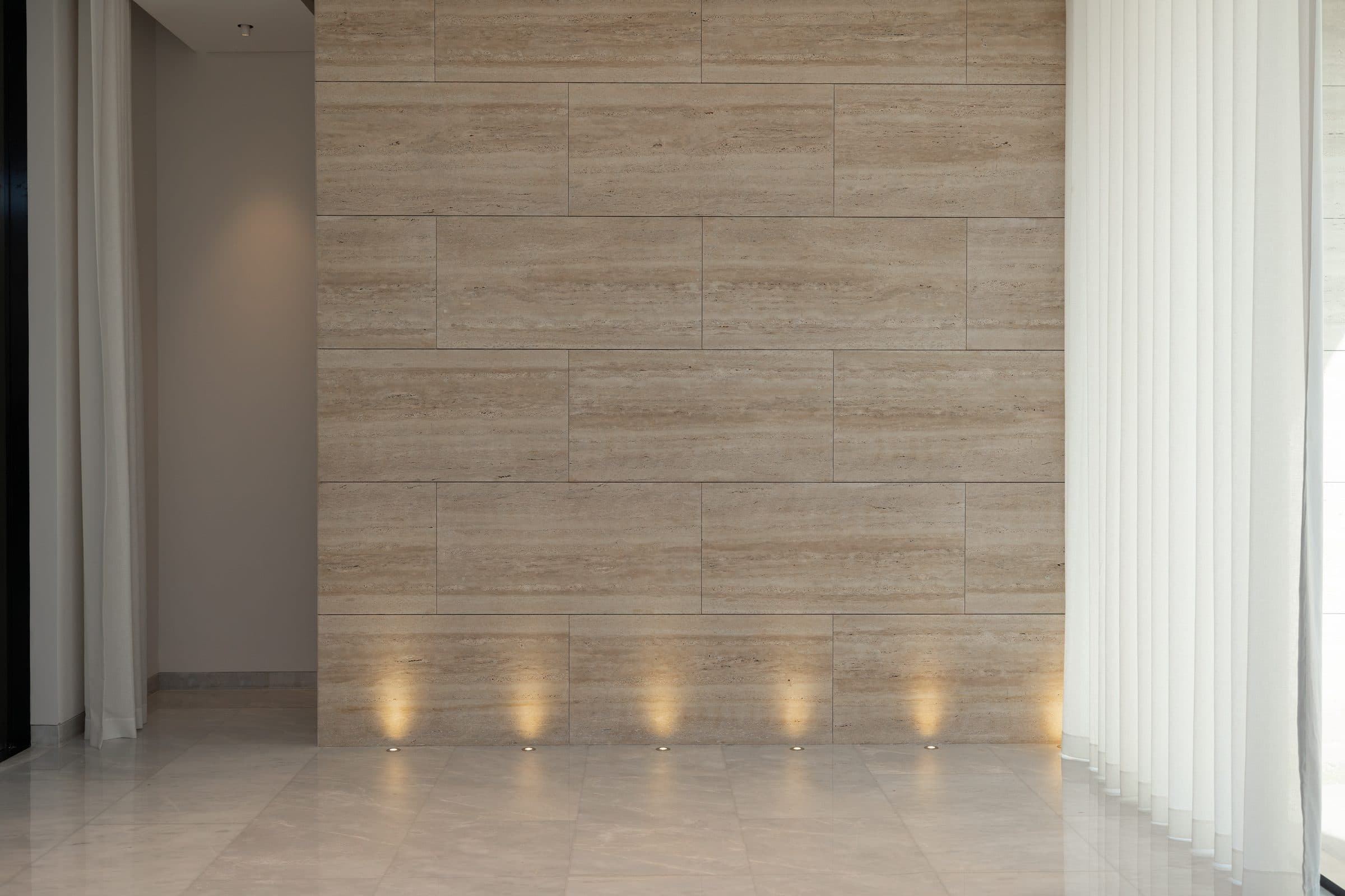 Travertine feature wall washed by uplights at The Travertine Villas, a LKYOOB commission