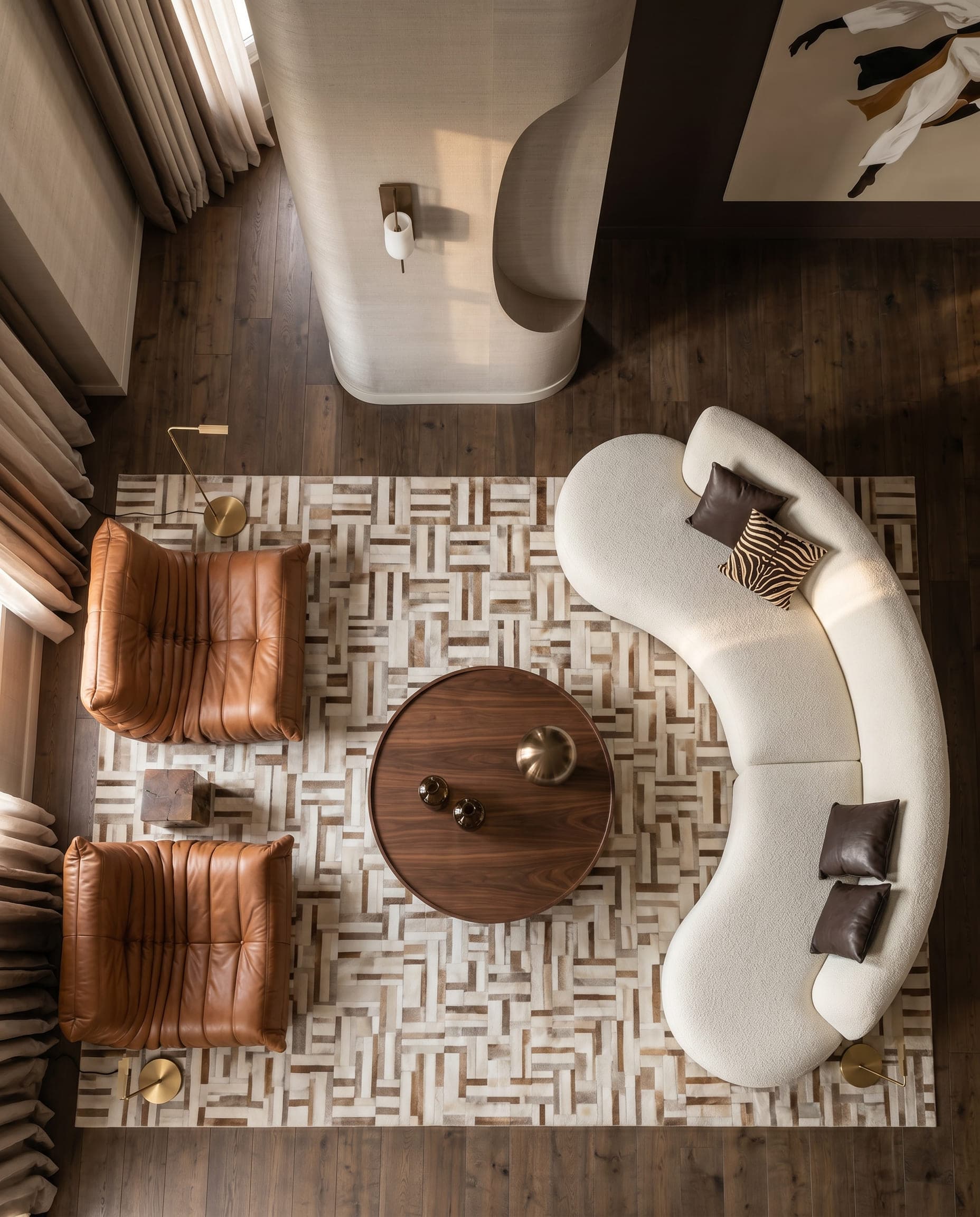 Design visualisation of the living room from above, a curved sofa and leather chairs around a round table, by LKYOOB