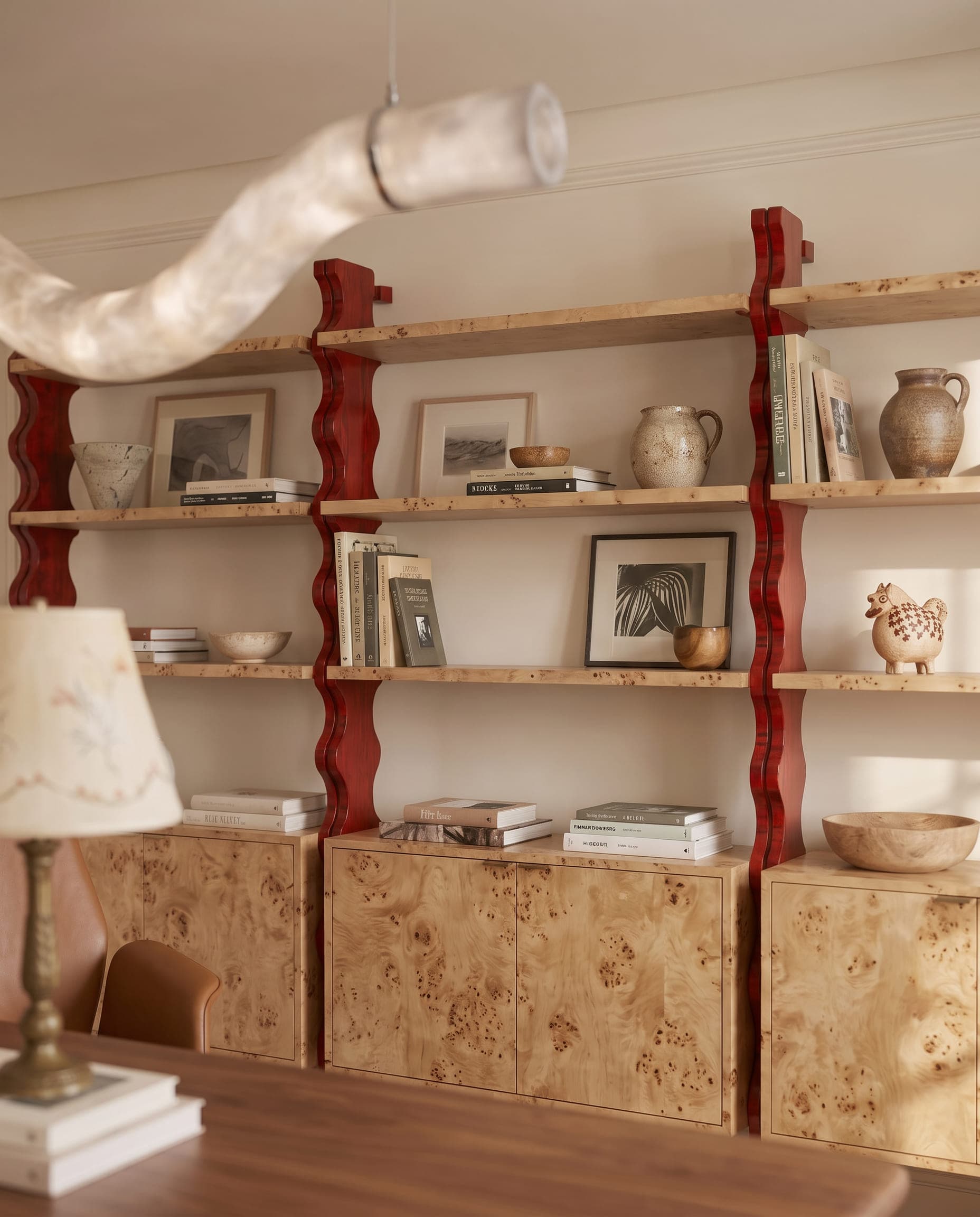 Design visualisation of the shelving in the study at Villa Eternelle, books and ceramics between red turned posts, by LKYOOB