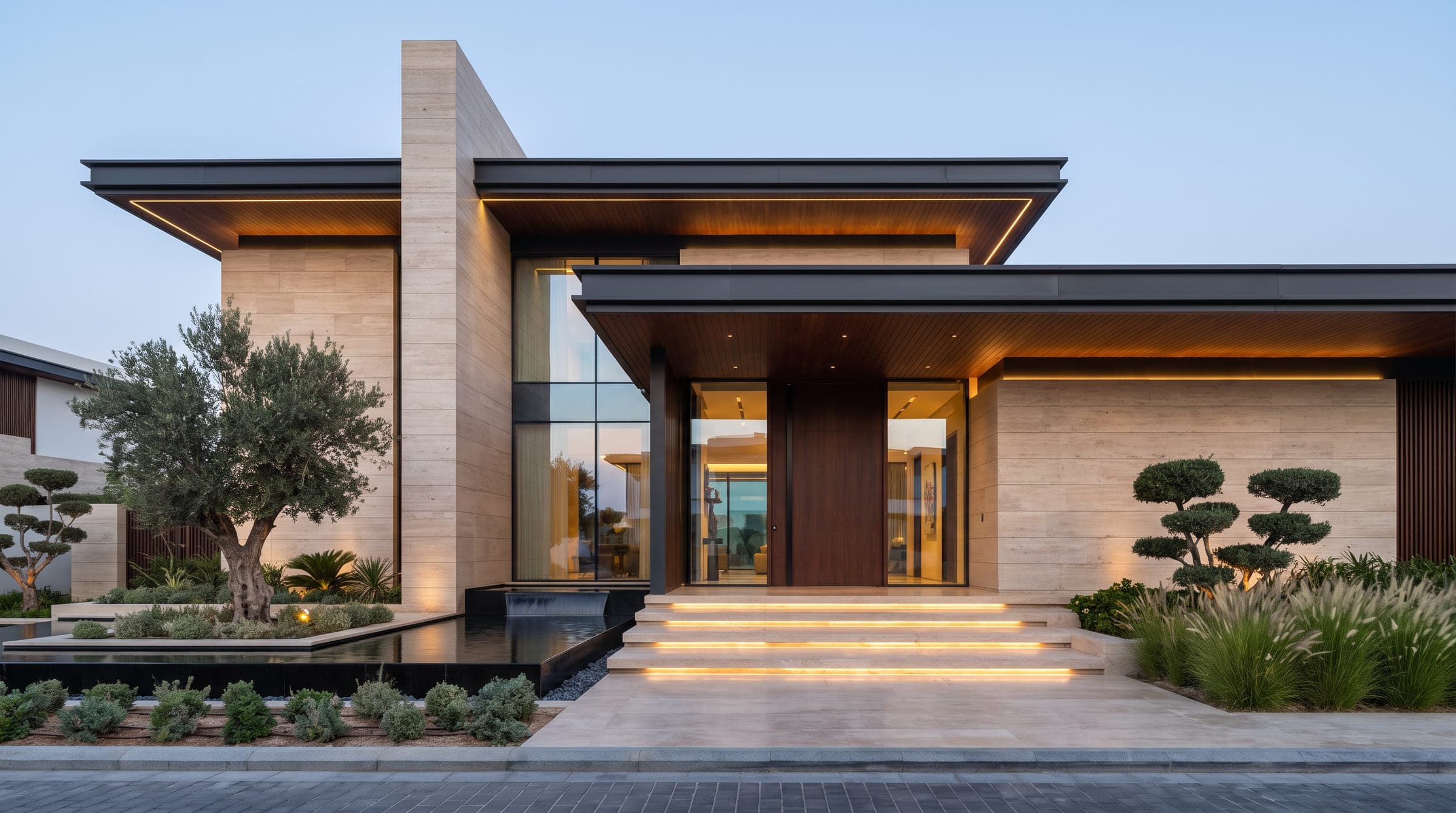 Design visualisation of Villa Sukoon from the street at dusk, travertine walls under deep timber-lined roofs, by LKYOOB